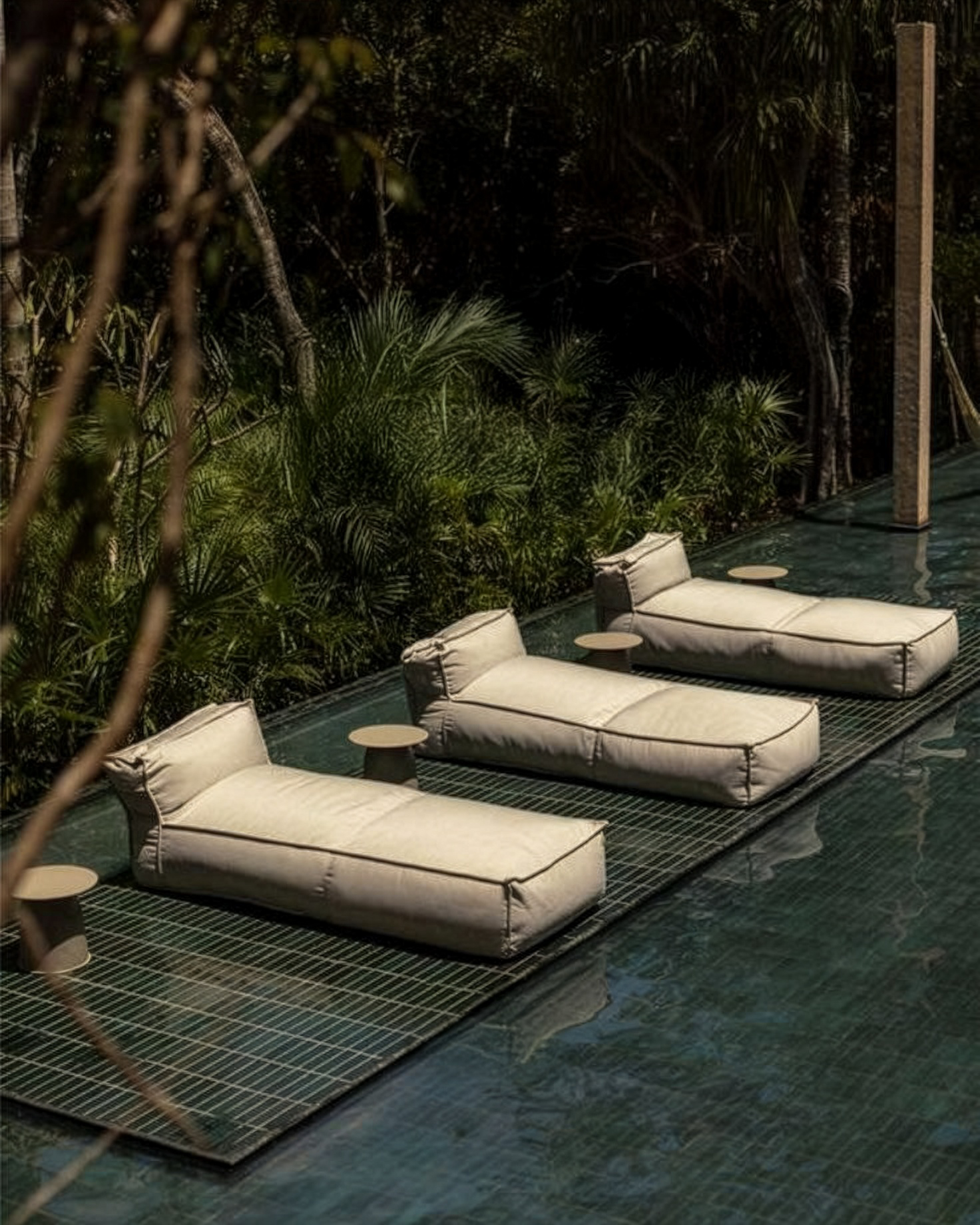 Luxury pool loungers in lush tropical setting